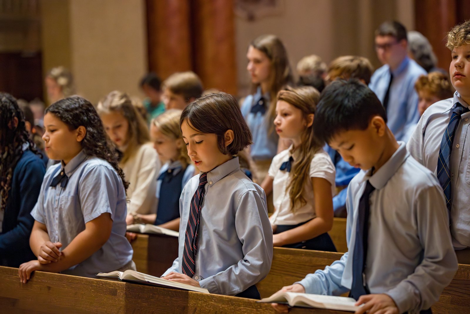 Students from Father Marquette Catholic Academy in Marquette pray during an all-school Mass. (Courtesy photo)