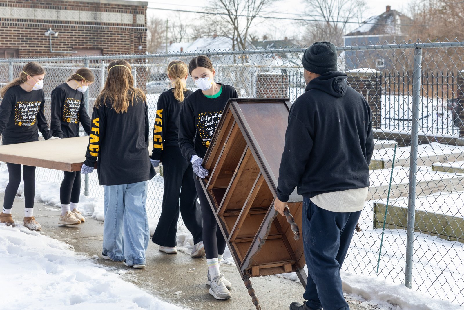 Young people from the National Shrine of the Little Flower Basilica in Royal Oak help moved furniture and supplies at Nativity of Our Lord Parish in Detroit on Jan. 17 during the annual Martin Luther King Jr. Day of Service, which took place at various locations throughout the Archdiocese of Detroit. (Steven Stechschulte | Special to Detroit Catholic)