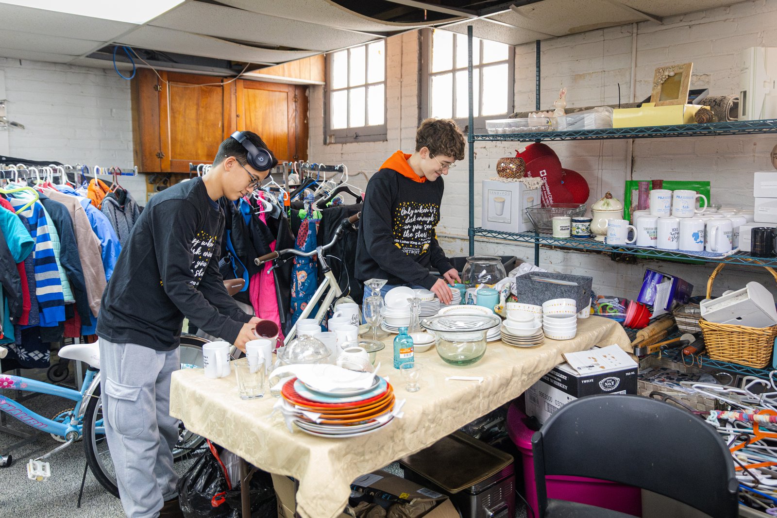Young people from the National Shrine of the Little Flower Basilica in Royal Oak organize supplies and items at Core City Neighborhoods in Detroit. (Steven Stechschulte | Special to Detroit Catholic)