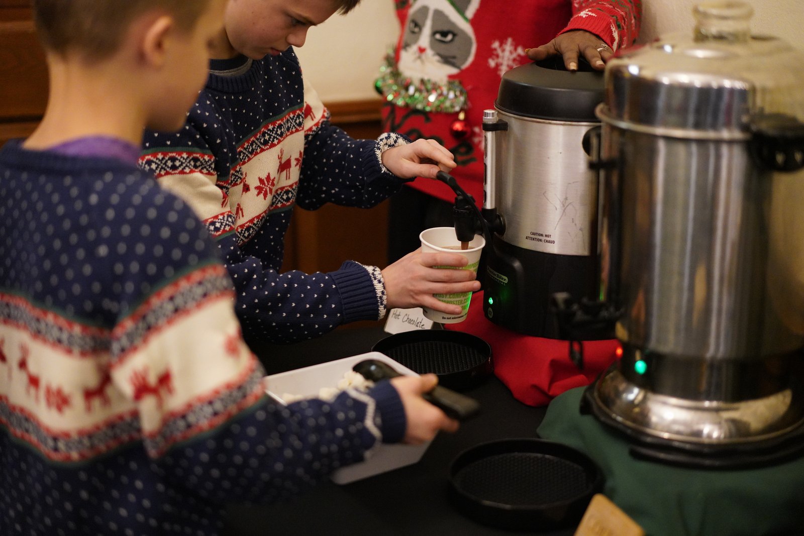 Detroit Catholic Campus Ministry students and alumni enjoy a hot chocolate bar and catch up during an hour of fellowship before watching the film "It's a Wonderful Life." (Courtesy of Alyssa Adamkiewicz)