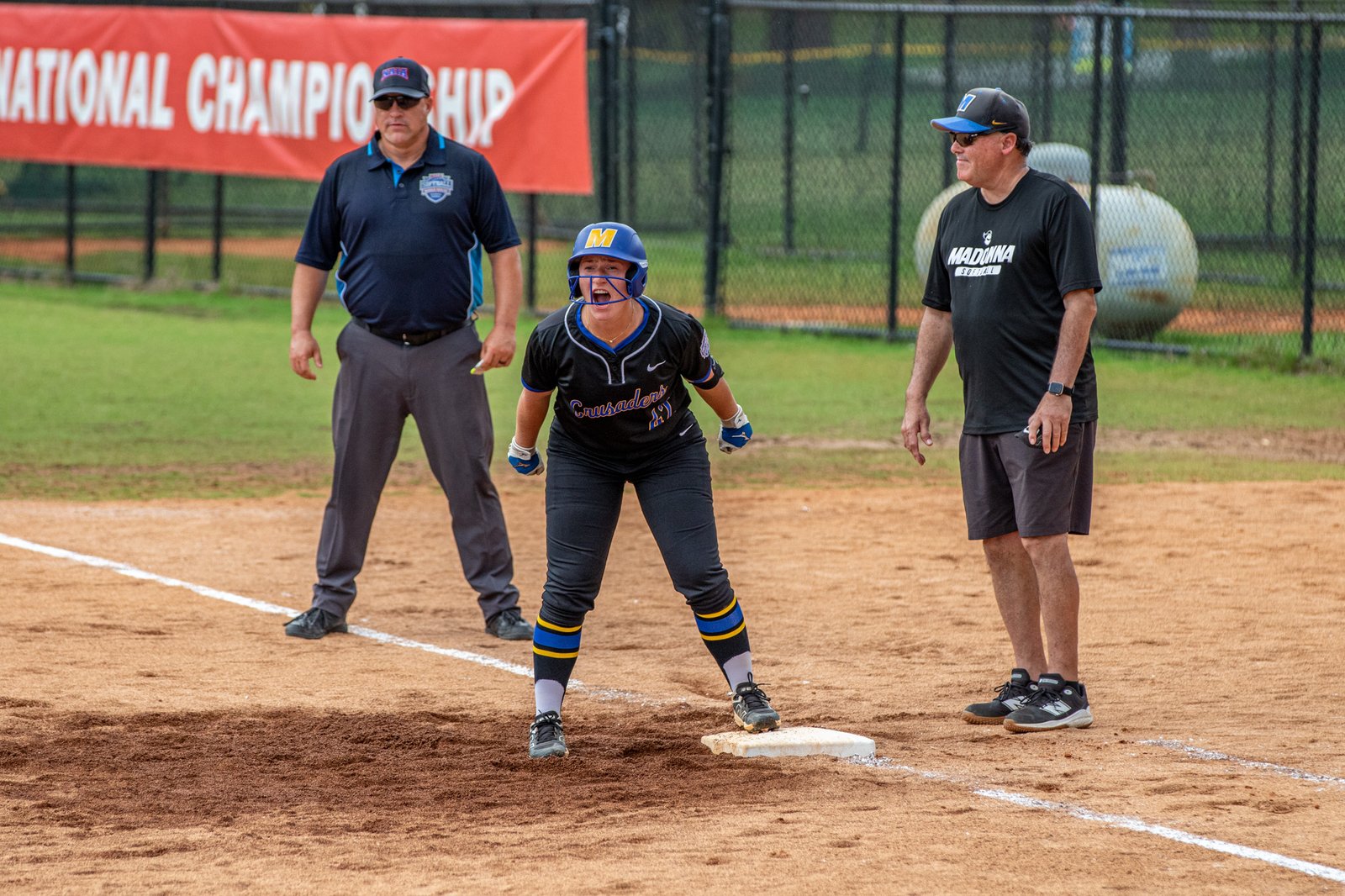 Rylee Fitzpatrick shouts with joy upon reaching first base on a fielder’s choice in the fourth inning. The play drove in Ashley Rosiewicz with the eventual game-winning run, helping Madonna University beat Southeastern (Fla.), 8-4.