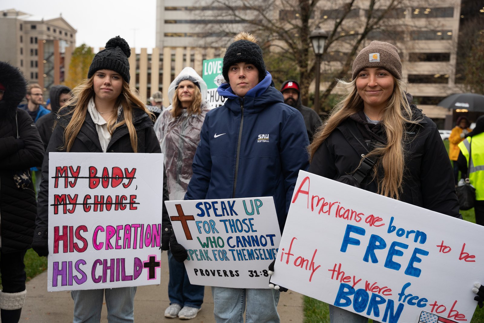 Students hold pro-life signs while braving the rain on the Capitol lawn in Lansing during the first-ever Michigan March for Life on Nov. 8, the one-year anniversary of the passing of Proposal 3.