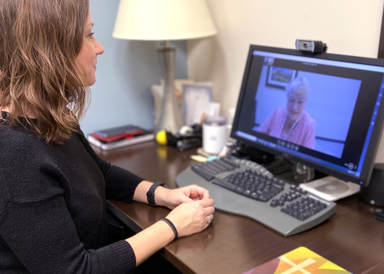 Amy Shipman, director of counseling, and Stephanie Spiser, office manager at Catholic Charities in Oklahoma City, illustrate telecounseling amid the coronavirus pandemic in this undated photo. (CNS photo/courtesy Catholic Charities, Archdiocese of Oklahoma City)
