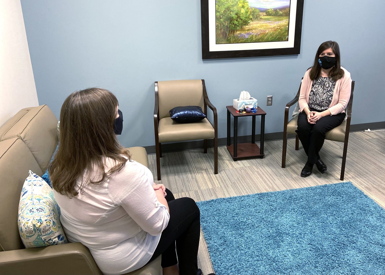 Monica Palmer, senior director of Clinical and Legal Services, and Aimee Ryan, director of Social Work, at Catholic Charities in Oklahoma City, illustrate how they provide in-person counseling amid the coronavirus pandemic in this undated photo. The old stigmas against mental illness have begun to weaken since the COVID-19 pandemic, as people acknowledge that asking for professional assistance is a constructive way to deal with the angst and unhappiness that plague our society today. (CNS photo/courtesy Catholic Charities, Archdiocese of Oklahoma City)