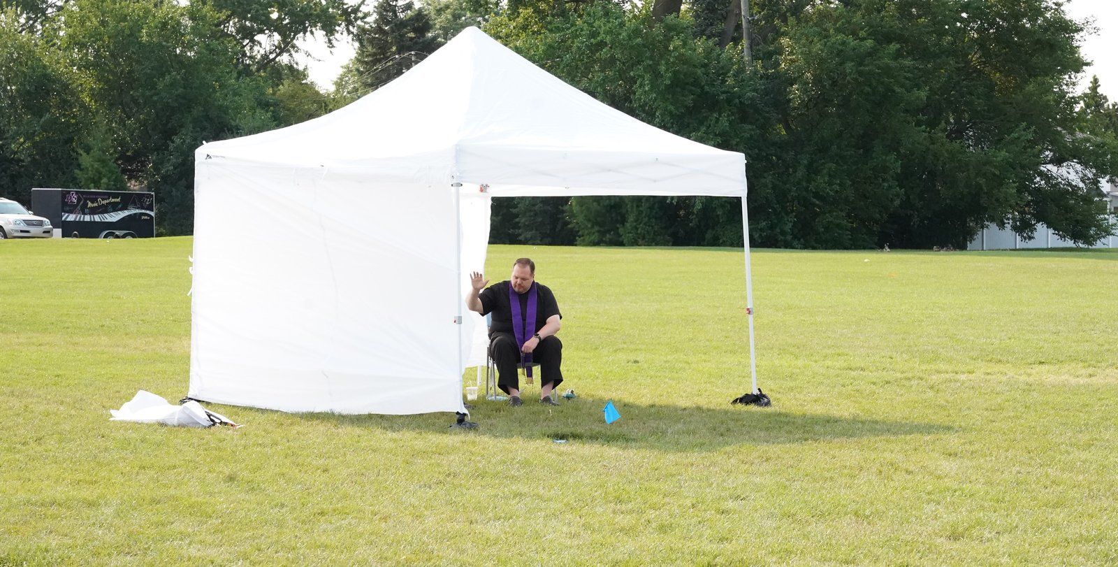 Fr. Andrew Smith of St. Paul on the Lake Parish in Grosse Pointe Farms listens to confession on game day in the Detroit Catholic Young Adult Soccer League. Confession is available for players before, during and after most games, with league leadership working with priest throughout the archdiocese to come to the game and listen to confessions.