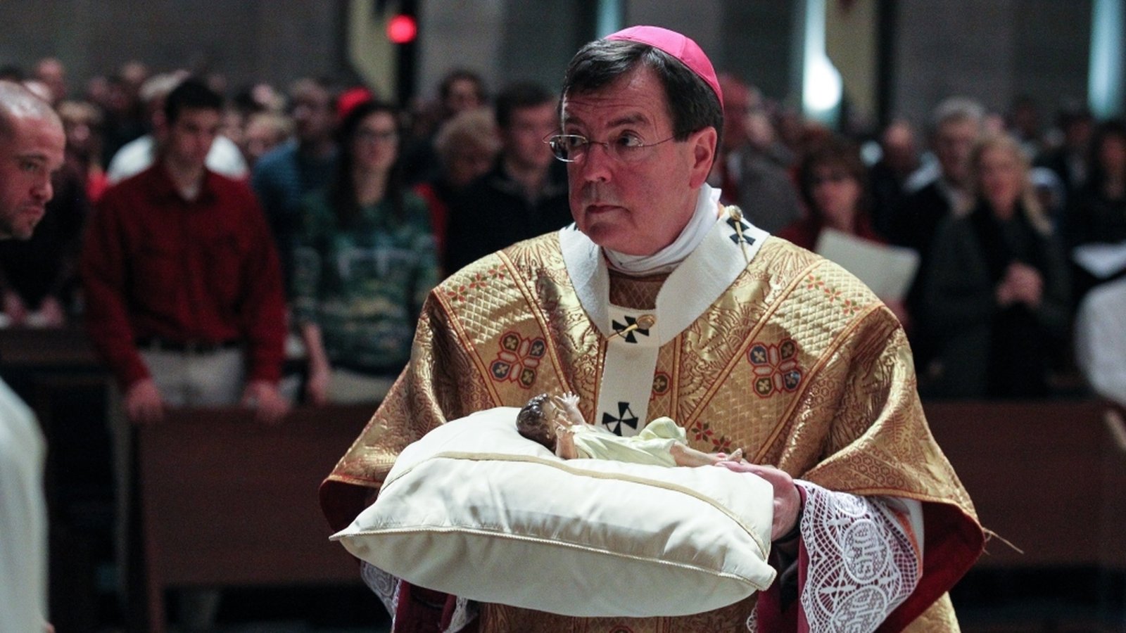 Archbishop Vigneron carries the Christ Child to the manger during Midnight Mass on Christmas Eve, Dec. 24, 2012, at the Cathedral of the Most Blessed Sacrament. (Larry A. Peplin | Detroit Catholic file photo)