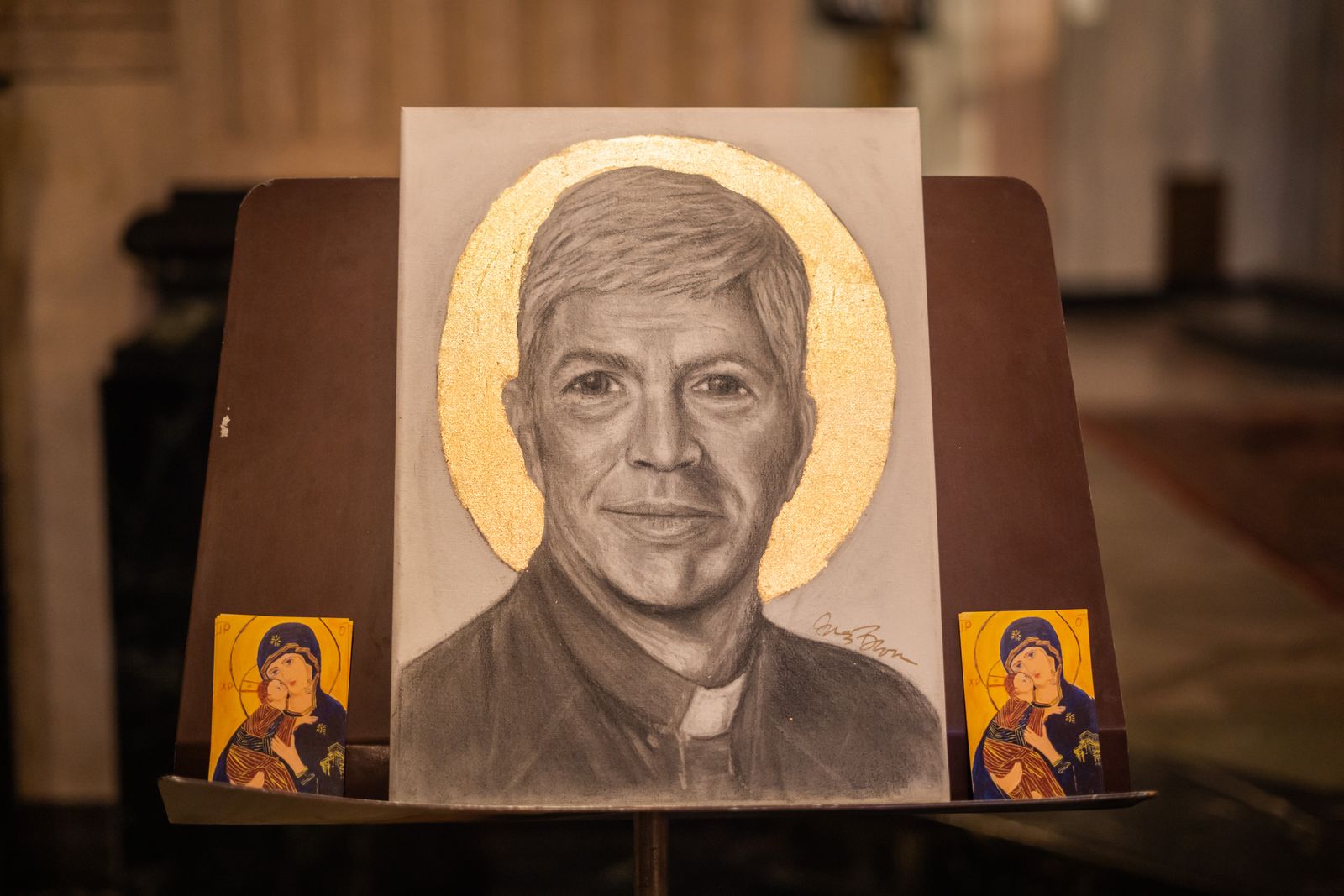 Brown said it took her approximately one day to make the black and white charcoal portrait. She used the image from Msgr. Trapp's funeral program as a reference.