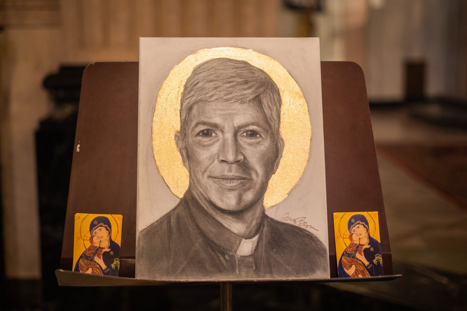 Brown said it took her approximately one day to make the black and white charcoal portrait. She used the image from Msgr. Trapp's funeral program as a reference.