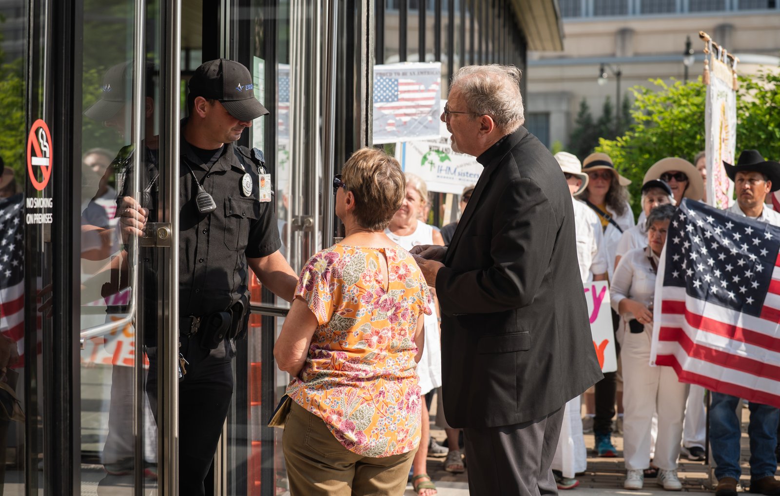 Fr. David Buersmeyer, chaplain for Strangers No Longer, and Judith Brooks, Strangers No Longer president, attempt to deliver a letter to Kevin Raycraft, field office director for U.S. Immigration and Customs Enforcement in Detroit. Building security did not permit Fr. Buersmeyer and Brooks to deliver the letter, but the group said it will seek to deliver the letter in other ways, possibly through local congressional leaders.