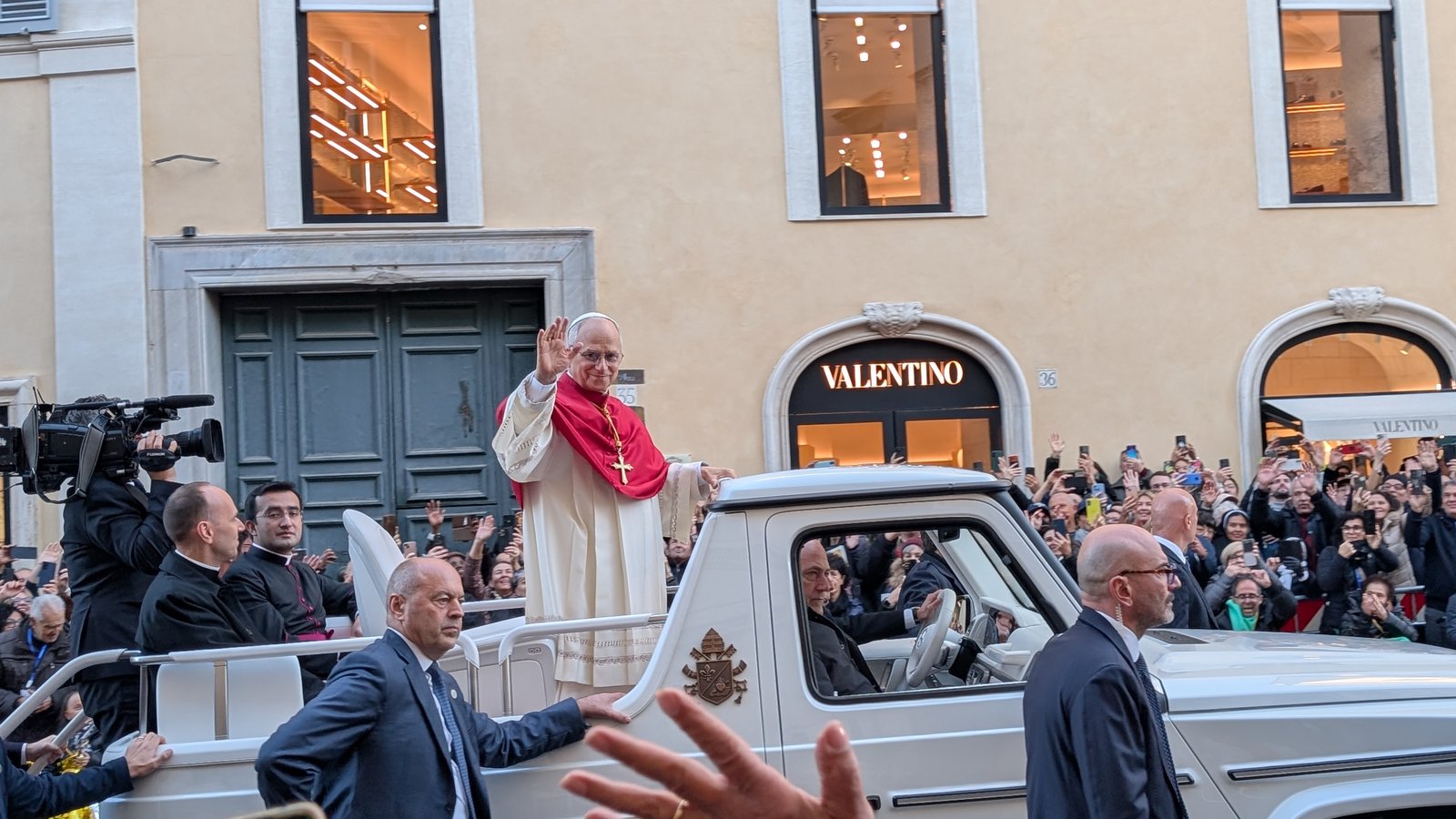 Pope Leo XIV waves to crowds of pilgrims from the popemobile during one of his public audiences in Rome.