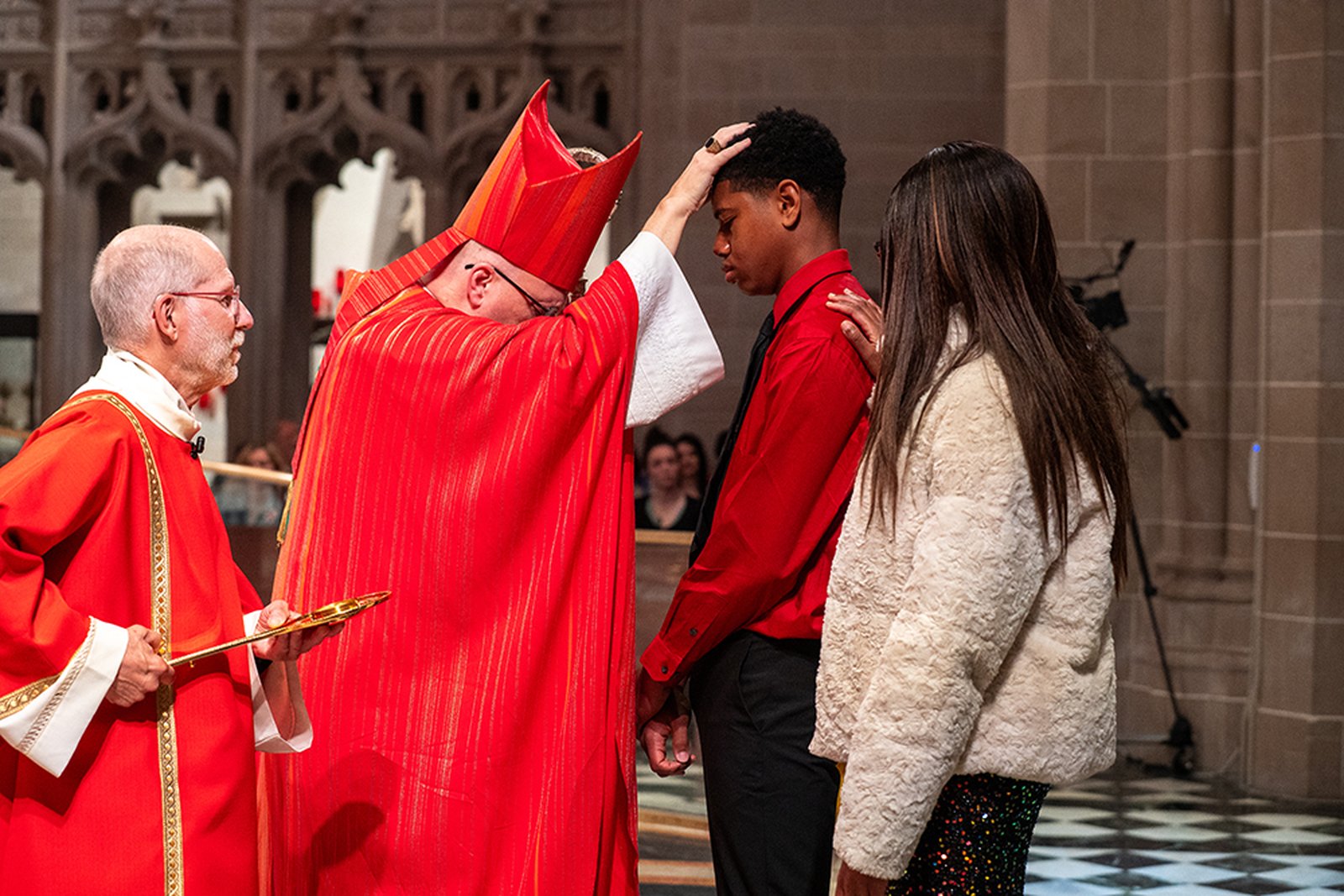 Archbishop Edward J. Weisenburger traces the sign of the cross upon a candidate's forehead with sacred Chrism oil June 8, the Solemnity of Pentecost, confirming him in the Catholic faith. Each year, the Archdiocese of Detroit celebrates the sacrament of confirmation of adults on Pentecost at the Cathedral of the Most Blessed Sacrament in Detroit. (Valaurian Waller | Detroit Catholic)
