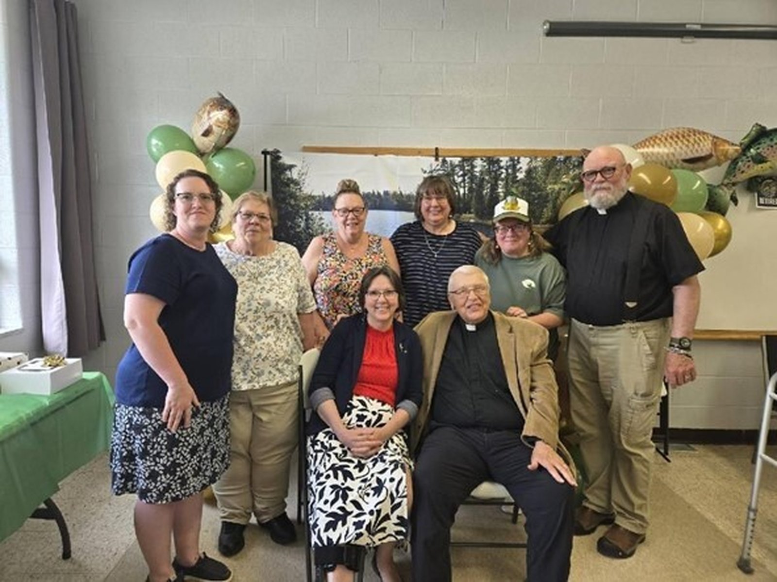 Friends visit with Fr. Treml during his retirement party in June 2025. Back row, left to right: Candy Doherty, Bernie Schlaud, Denise Edwards, Barb Sinka, Paula Kaniut and Deacon Pete Lynch. Front row: Margaret Almand and Fr. Richard Treml.