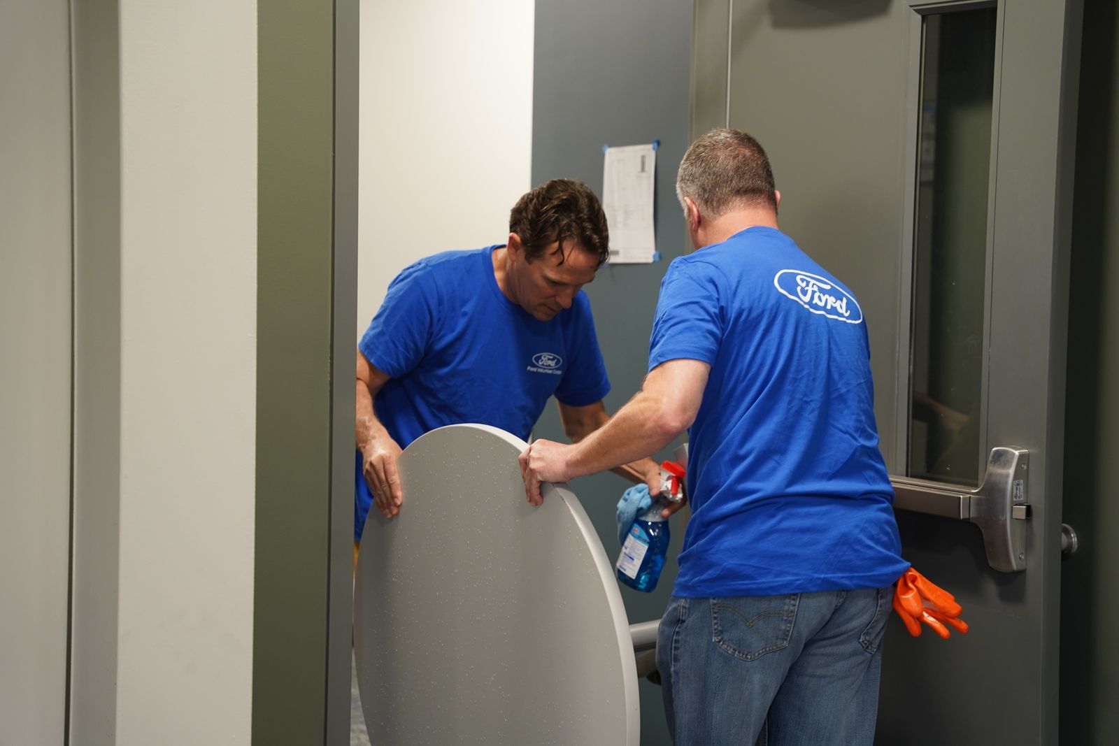 Team members from Ford Land move in furniture to the Pope Francis Center bridge housing facility on May 3. The facility will feature a medical and dental clinic, social workers and housing advocates who will work with the Pope Francis Center's guests to place them into more permanent housing. A chapel will also be on site.