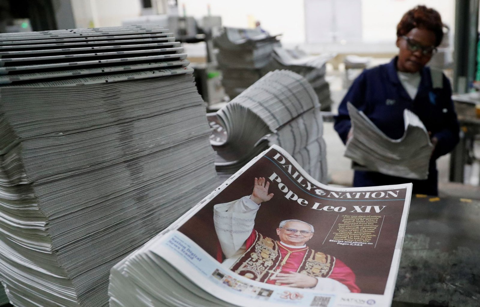 A worker arranges printed newspapers for circulation with a photo of the newly elected Pope Leo XIV, Cardinal Robert Prevost of the United States, at the Nation Media Group printing press on the outskirts of Nairobi, Kenya, May 8, 2025. (OSV News photo/Thomas Mukoya, Reuters)