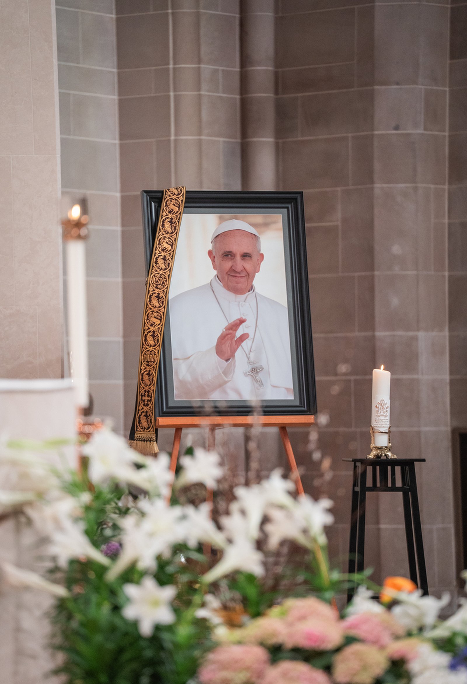 A stole hangs from a portrait of Pope Francis in the sanctuary of the Cathedral of the Most Blessed Sacrament. For nine days, the Church will mourn Pope Francis' passing before the College of Cardinals gathers to begin the process of electing a new pope.