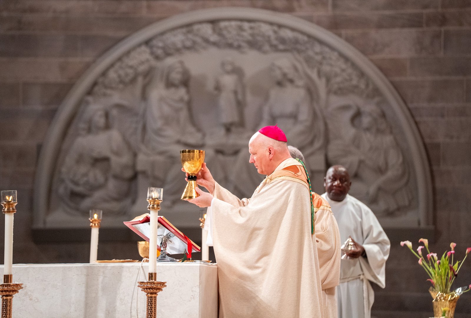 Archbishop Weisenburger consecrates the Eucharist during a vigil Mass for the Fourth Sunday of Easter at the Cathedral of the Most Blessed Sacrament in Detroit on May 10. The archbishop led local Catholics in giving thanks for the May 8 election of Pope Leo XIV, the former U.S.-born Cardinal Robert F. Prevost.