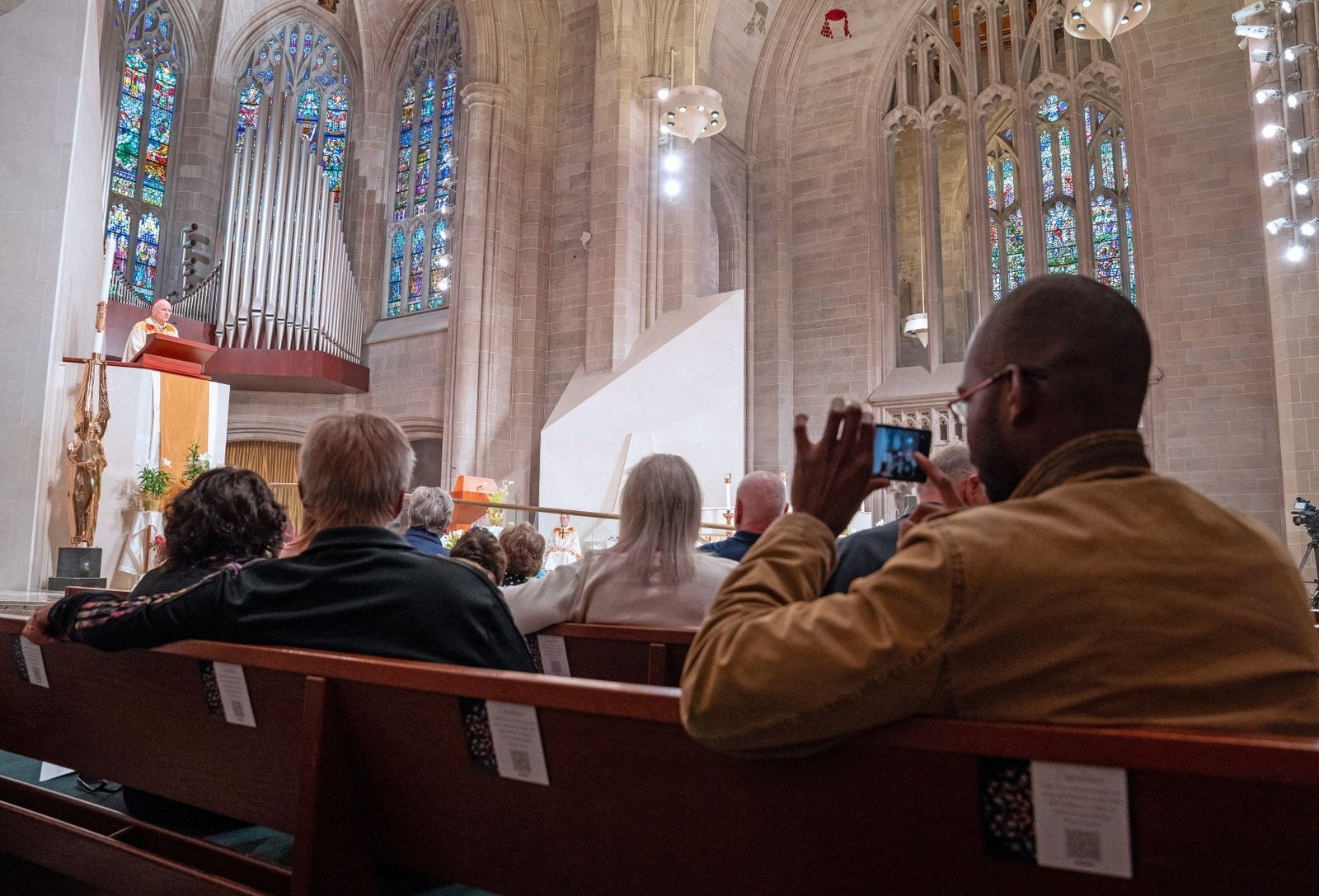 Members of the faithful listen to Archbishop Weisenburger's homily, in which he reflected upon Christ's gift of the Petrine ministry, which he called a "focal point of unity" for the Church over 2,000 years.