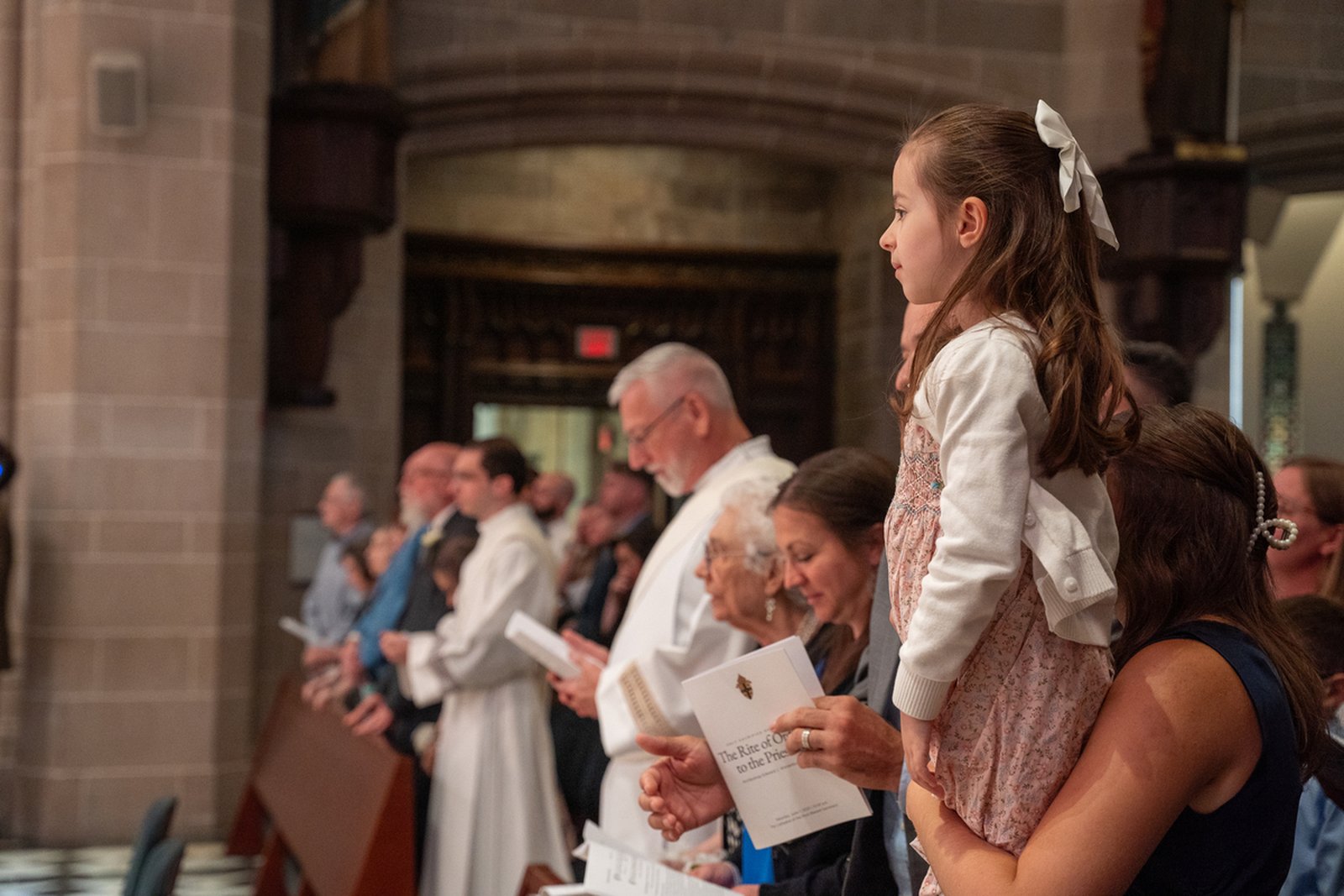 Family members look on as Fr. Schroder and Fr. Bruen prepare for ordination. Fr. Schroder's parents and Fr. Bruen's children were in attendance during the Mass.