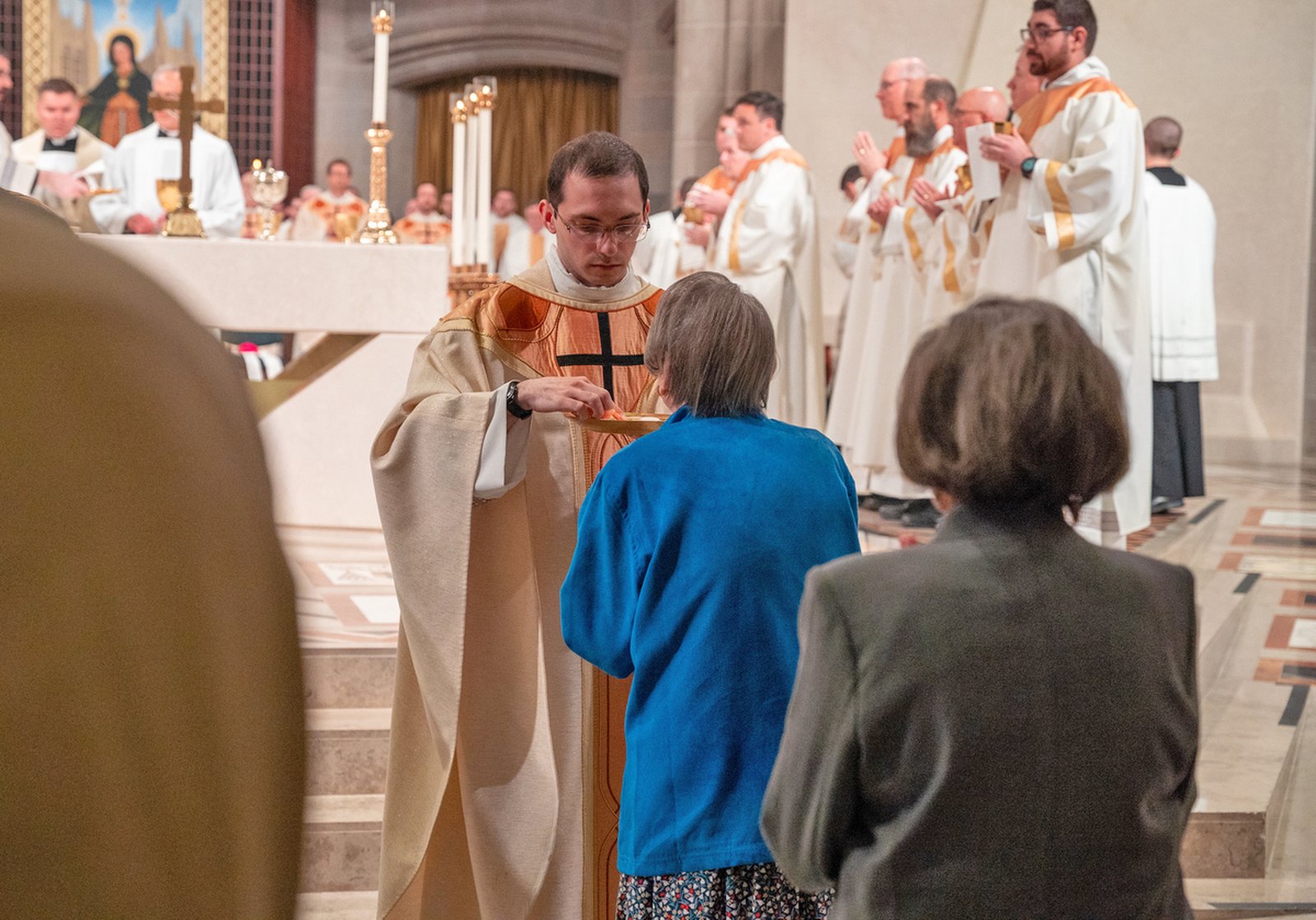 Fr. Schroder offers Communion to members of the faithful for the first time as a priest June 7. Fr. Schroder's father said the new priest began discerning the priesthood while in high school.