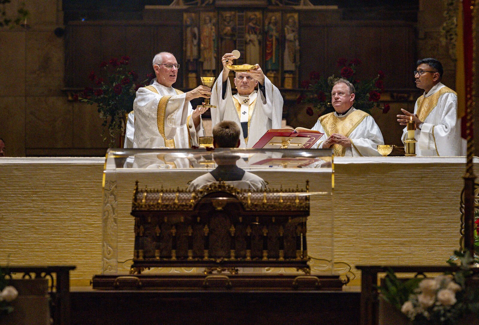 Archbishop Weisenburger elevates the consecrated host during the Communion rite. In his homily, Archbishop Weisenburger encouraged the faithful gathered to consider the "little ways" they can live lives of holiness.