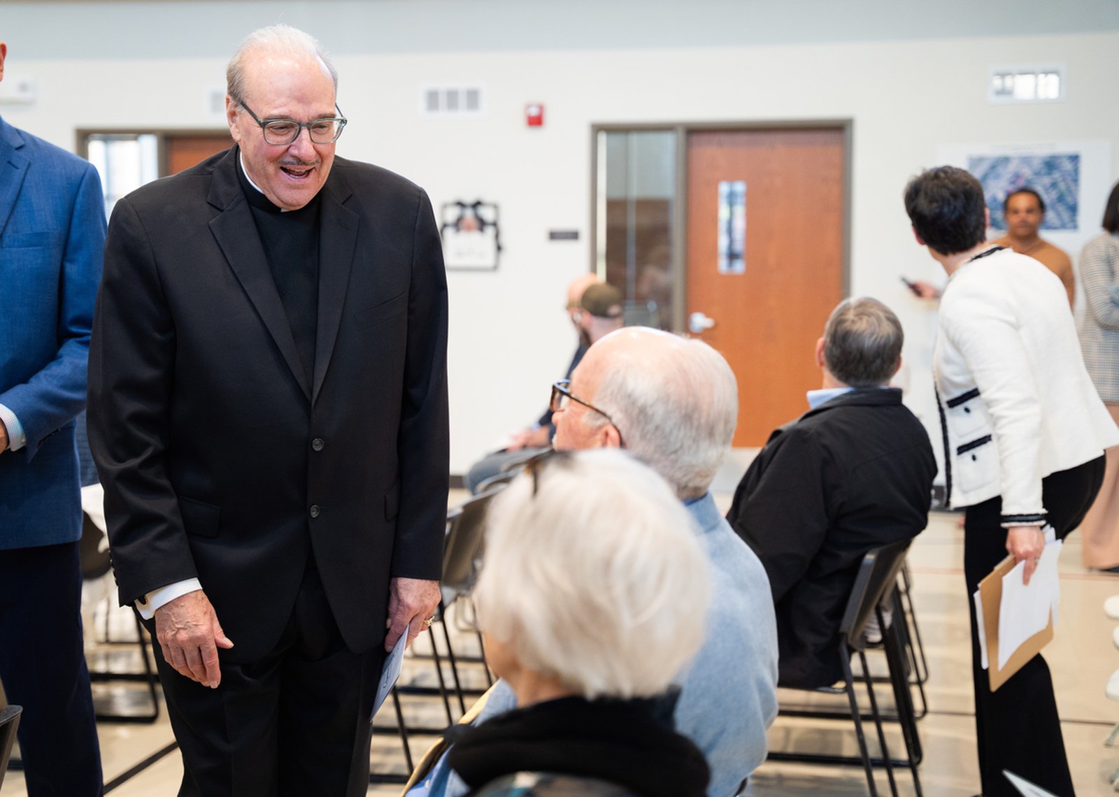 Fr. Duane Novelly, the longtime pastor of St. Matthew Parish on Detroit's east side who continues to serve the parish community, greets guests during the press conference.
