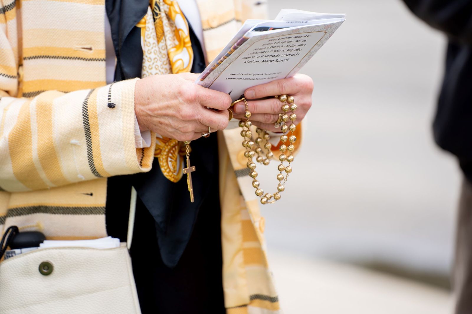 An Our Lady of the Scapular parishioner prays the rosary with fellow pilgrims along the rosary walking route May 1.