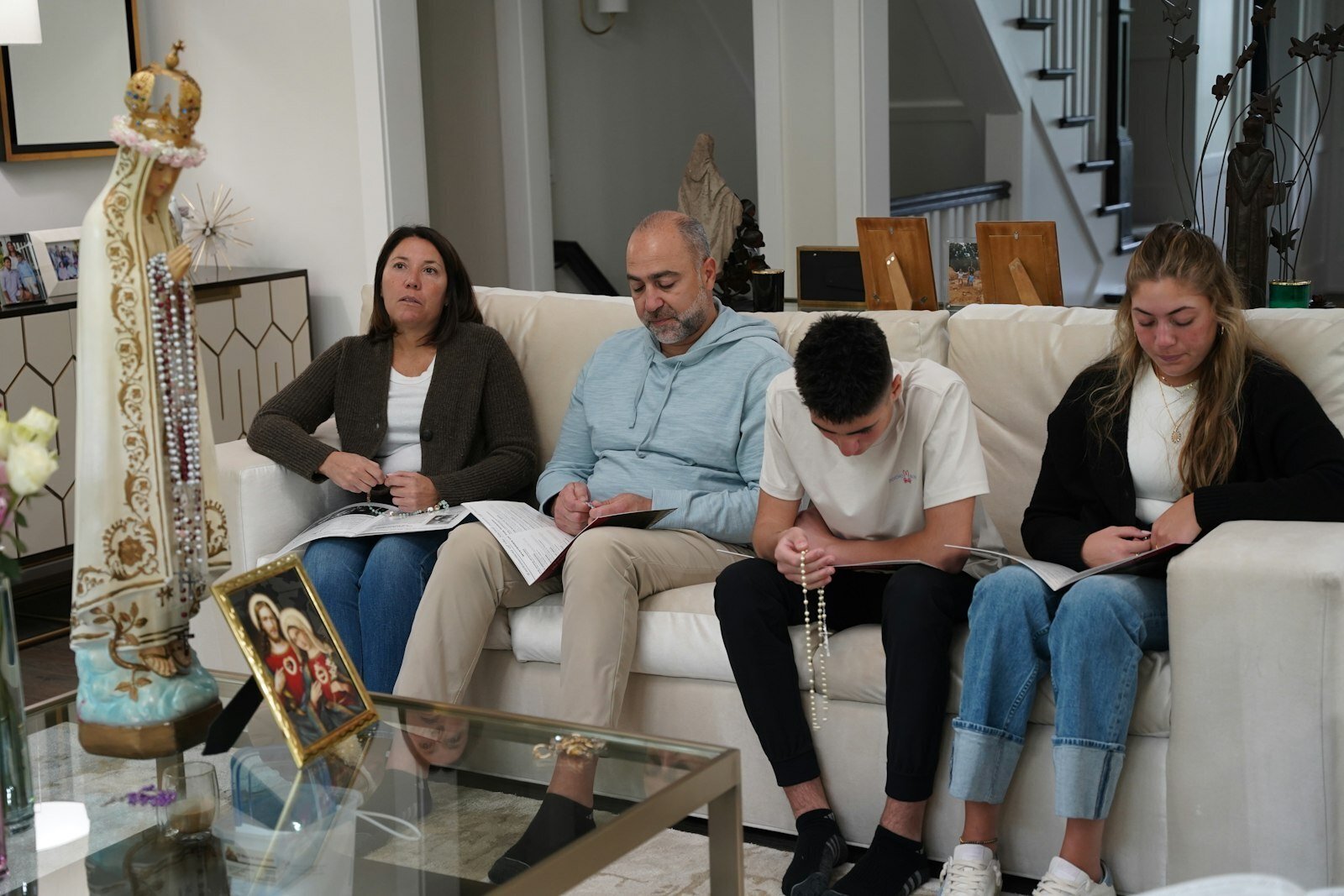Saba and Anthony, along with two of their children, Eliana and Liam, pray the rosary together during the Sacred Heart enthronement May 11. It’s been 350 years since Jesus appeared to St. Margaret Mary Alacoque of France, to whom he revealed his request for the world to be converted to his Sacred Heart. During home enthronements, a statue of Our Lady of Fatima is installed in a family's home for two weeks, encouraging intercessory prayer together.
