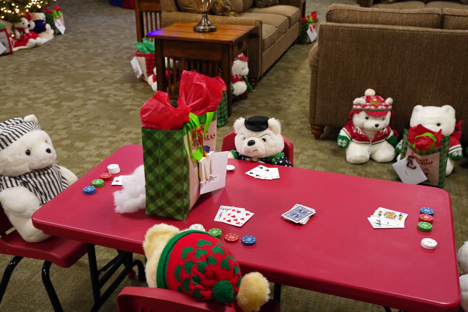 Santa Bears playing Euchre as they await children from the religious education program to grab their Christmas gifts.