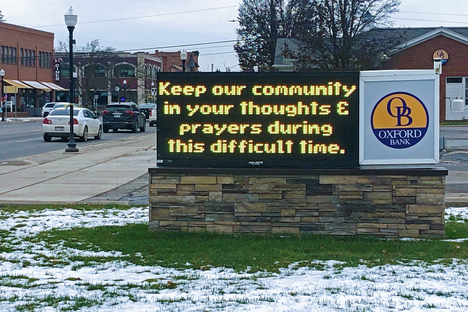 A sign displayed outside Oxford Bank in downtown Oxford asks for prayers for victims and their families Dec. 1.