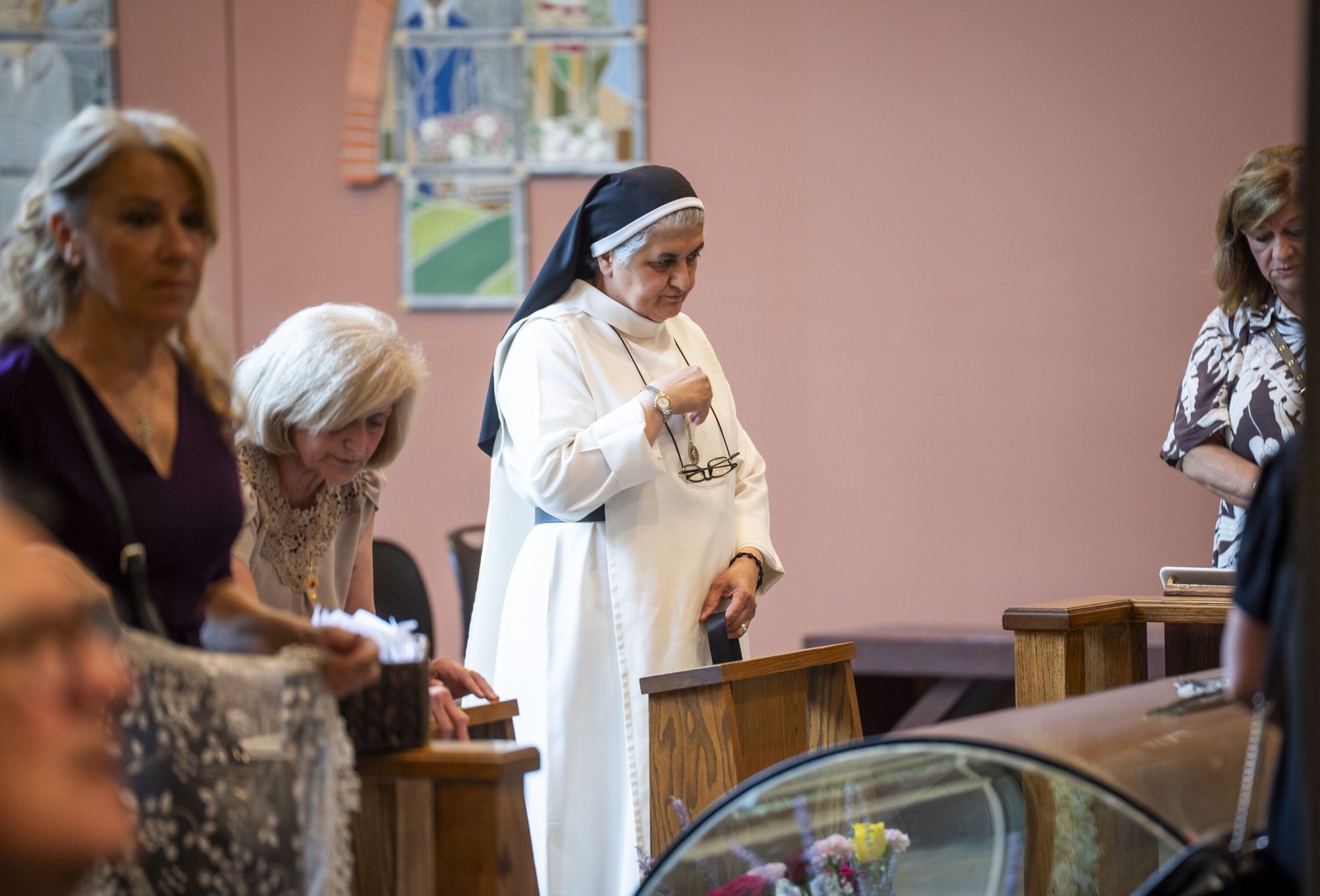 A Chaldean sister prays next to the tomb of Blessed Solanus Casey on his feast day, July 30, at St. Bonaventure Monastery in Detroit.