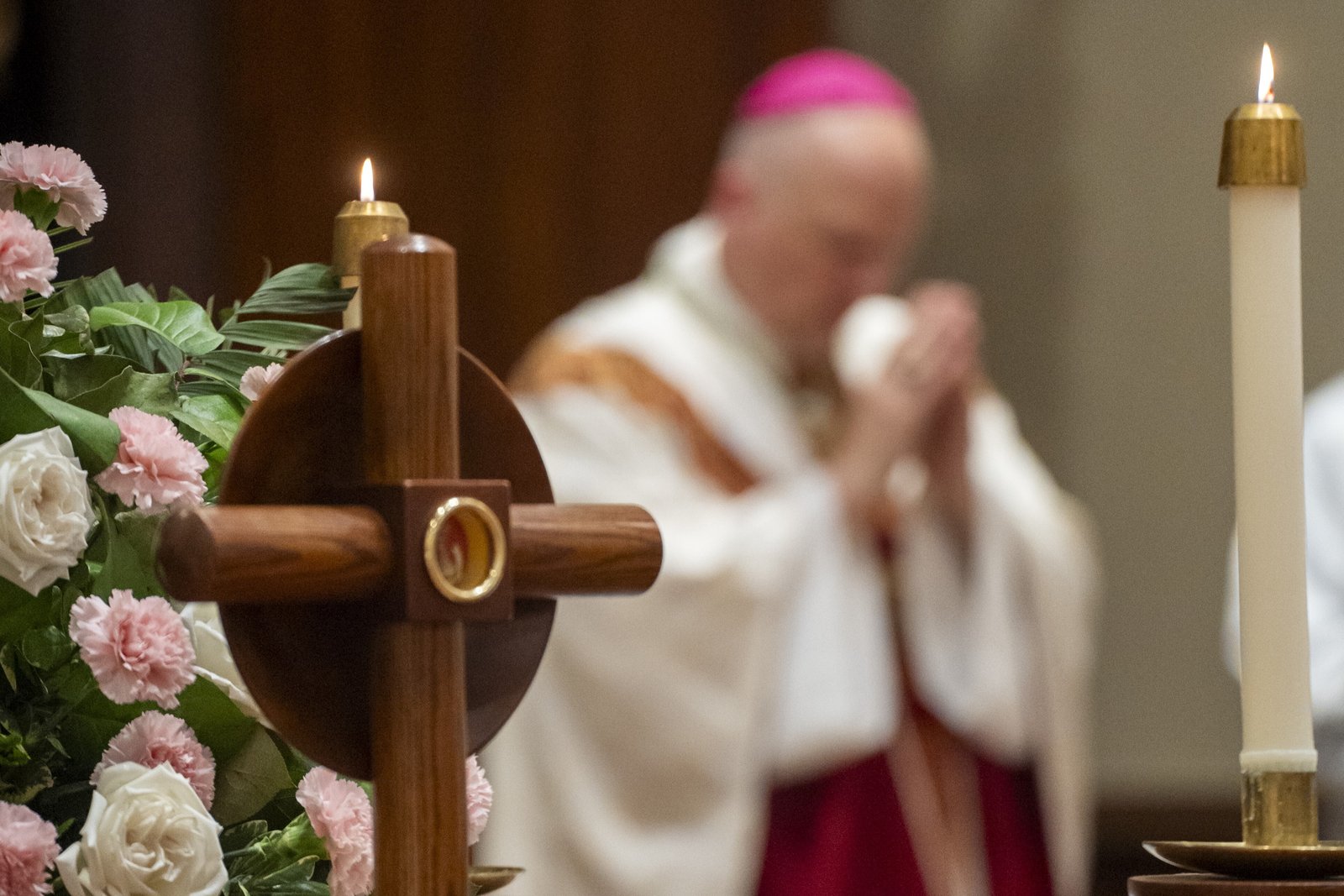 A first-class relic of Blessed Solanus Casey is displayed in the sanctuary of St. Bonaventure Monastery in Detroit as Archbishop Weisenburger (background) celebrates Mass.