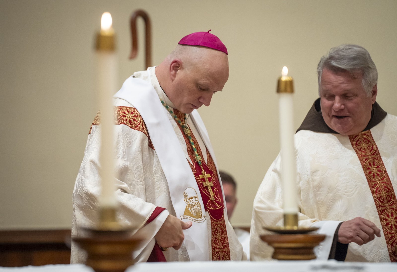 Archbishop Weisenburger admires the stole given to him as a gift by the Capuchins. The stole was made by Nancy Long, the head of the Eucharistic Mission Band, using a design by the late Bro. Mike Gaffney, OFM Cap.