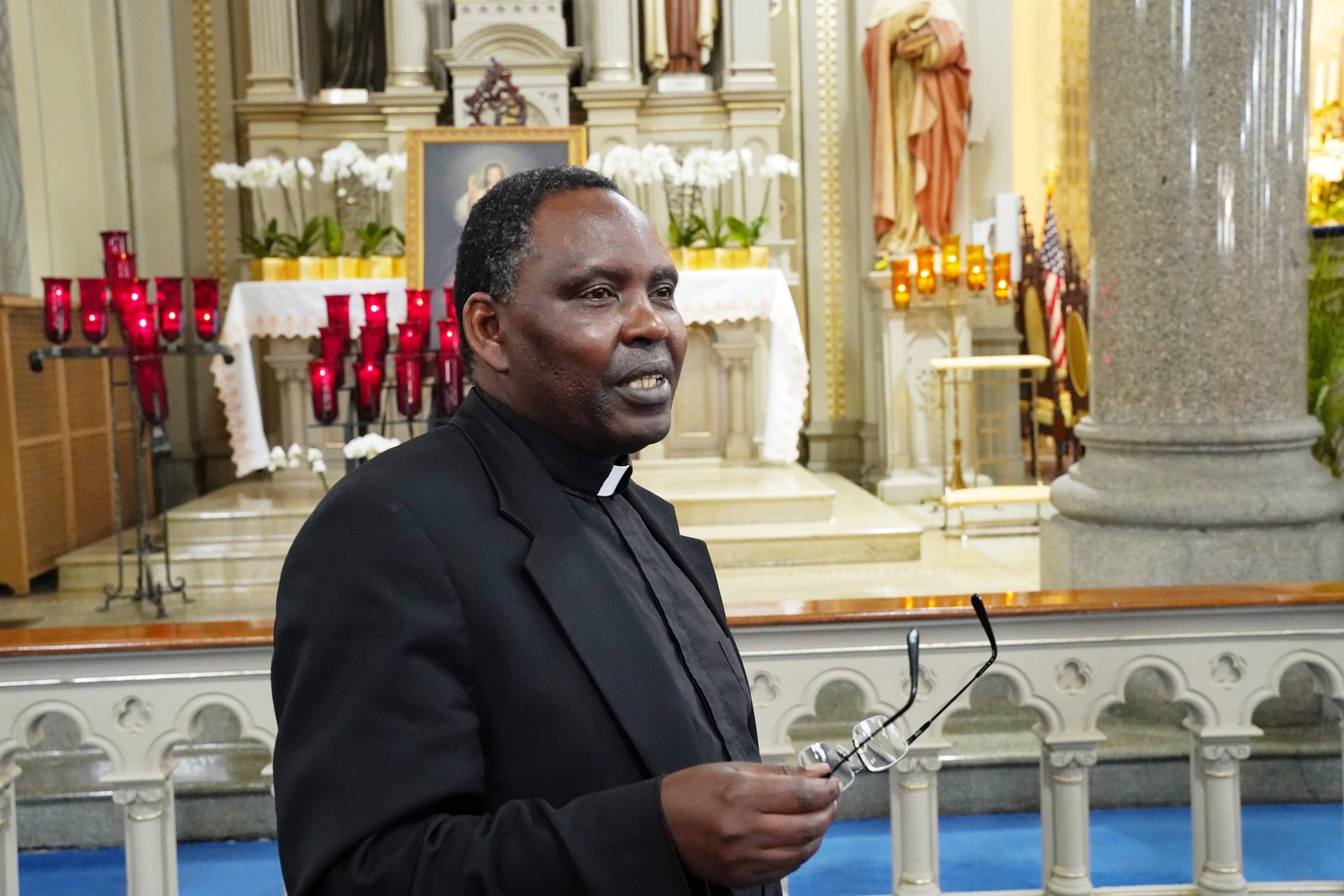 Fr. Godfrey Mgonja, C.S.Sp., the priest in solidum at Old St. Mary's, speaks to a reporter following a weekday Mass. The Holy Ghost Fathers (Spiritans) have been serving at St. Mary's for 132 years and will celebrate their final Mass at the parish this Sunday. (Daniel Meloy | Detroit Catholic)