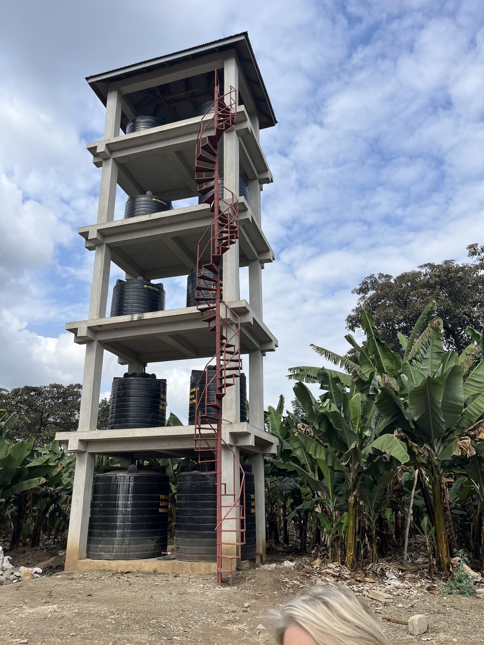 The water store tank tower for the 1,300 girls. They pump 10,000 liters of water per hour twice a day for showers. Water from these tanks are used for toilets and by the kitchen for cooking and cleaning.