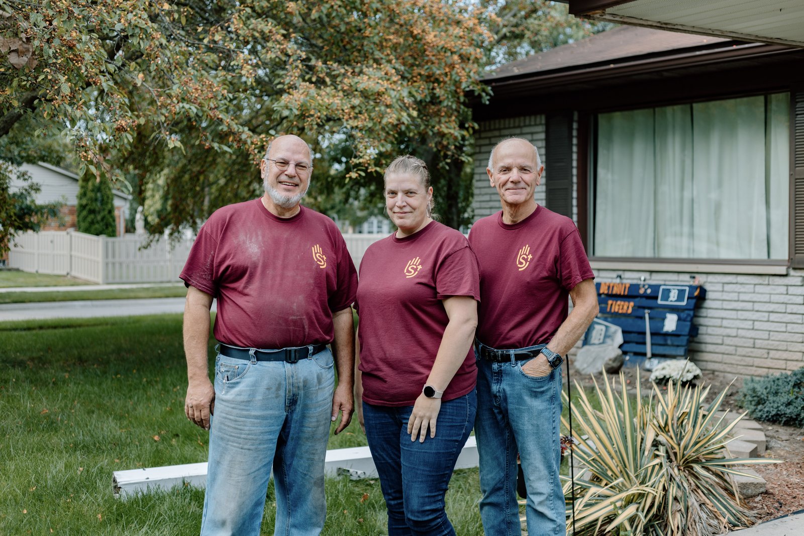 Left to right, volunteer Mark Hill, Tony Rosati, president of St. Joseph's Helpers, and Rayna Bennet, the apostolate's executive director, pose for a photo while working on a client's house in Woodhaven. A nonprofit organization founded on Christian values, St. Joseph's Helpers complete home improvement projects and offer clients prayer and accompaniment in the process.