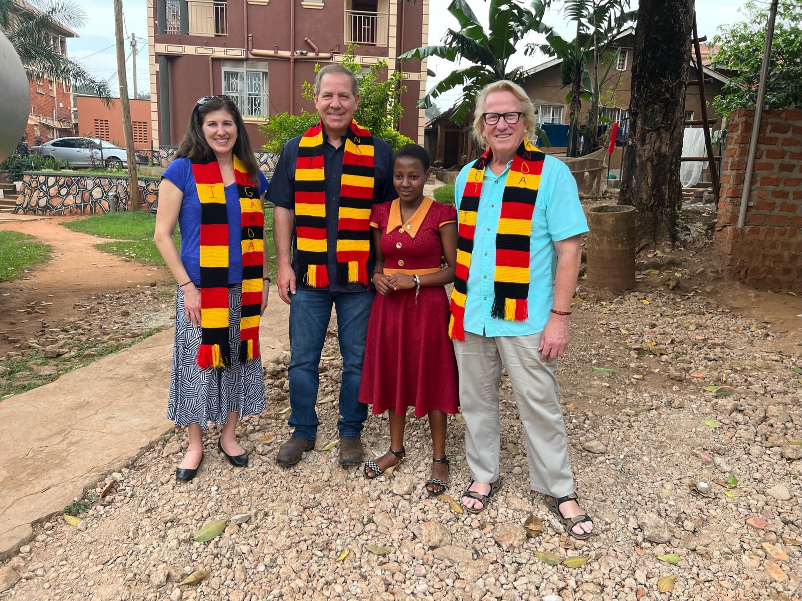 Jasmin Walker, Chuck Salter and Bill Tulloch receiving handmade gifts from a St. Kizito parishioner.