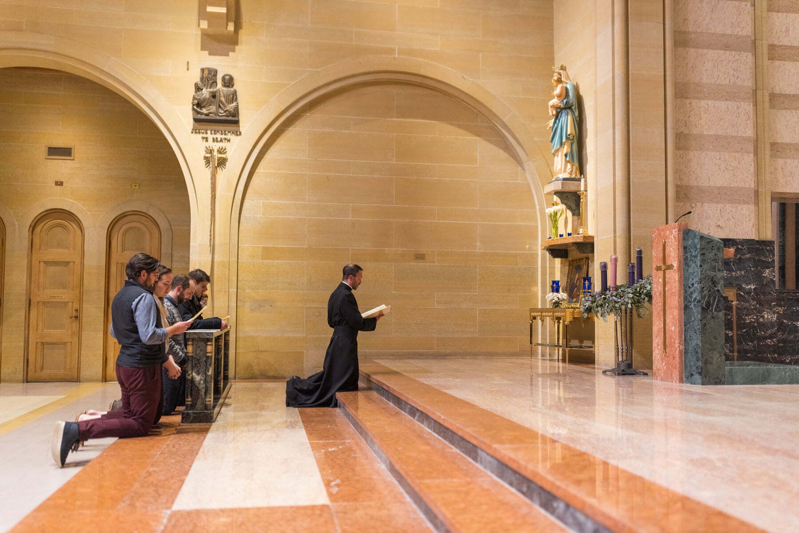 Fr. Paul Snyder leads parishioners in a prayer to the Blessed Virgin Mary in December 2021. A statue (not the one pictured) was destroyed at the parish when a suspect broke into the vestibule March 8. (Courtesy of St. Mary Parish)