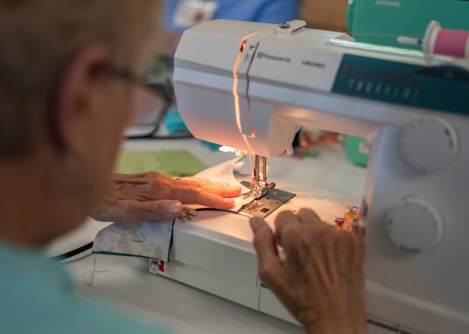 Working as a team in an assembly-line fashion, the women patiently construct reusable sanitary pads that they bundle up to send off with nonprofits and mission groups who bring the products to girls in countries where accessibility to feminine hygiene products are limited.
