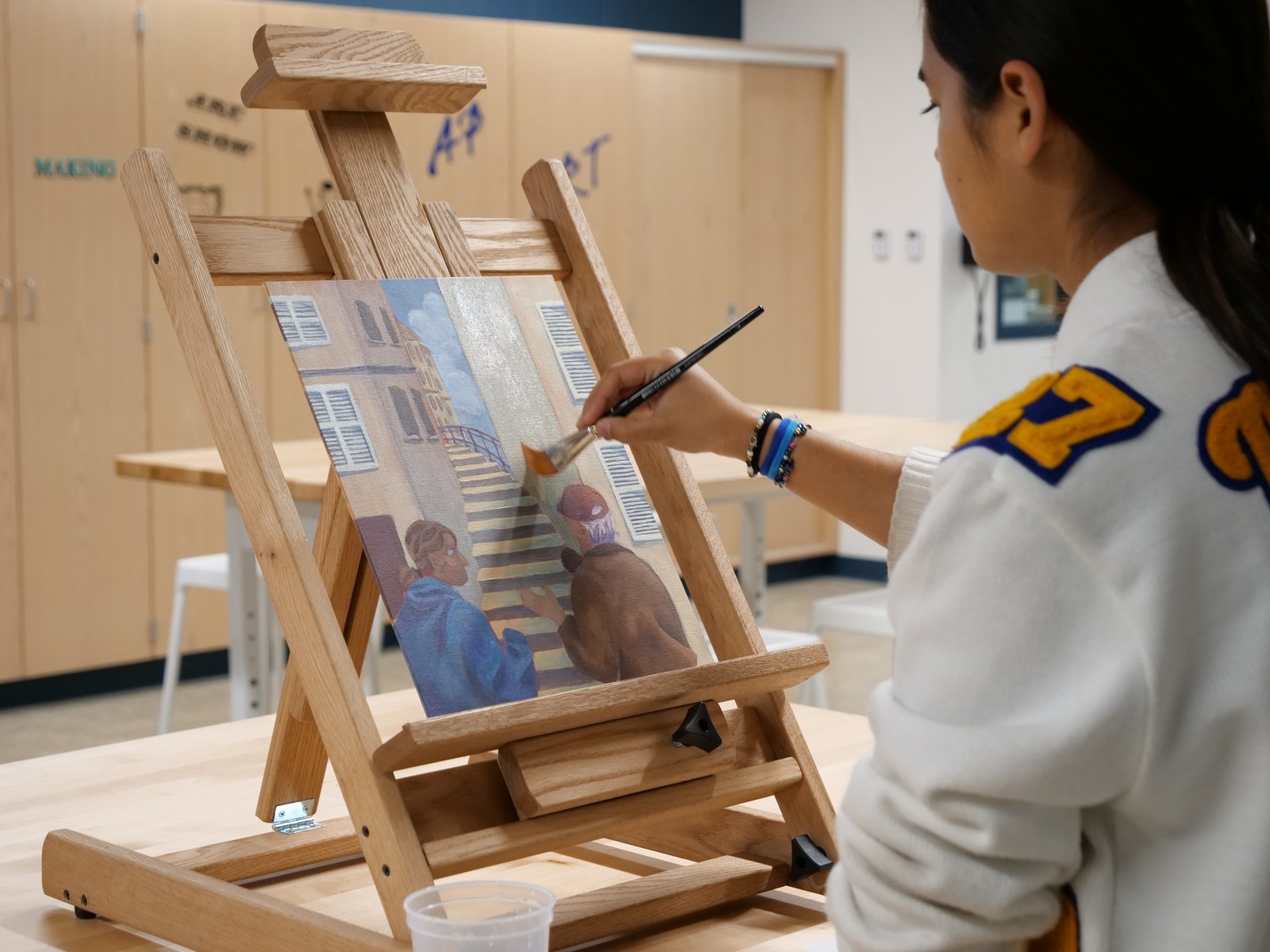 A Marian student points on a canvas in Marian's new Wanink Art Wing.