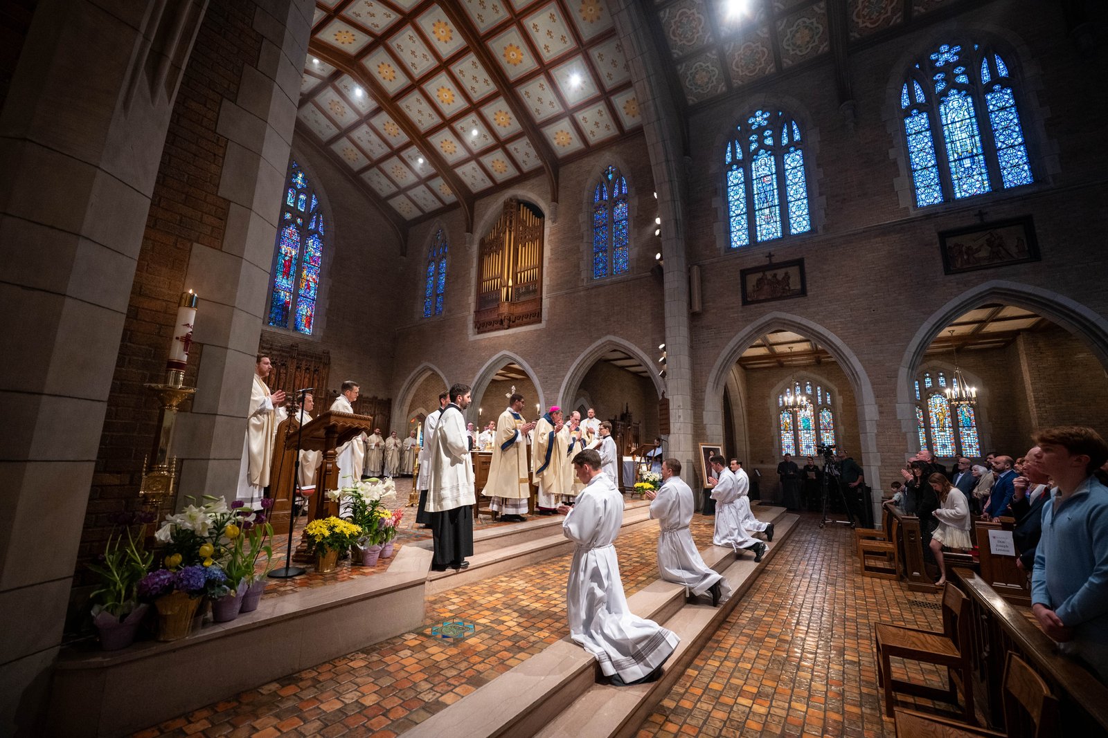 Four men kneel before the altar before their names are called to present themselves before Archbishop Vigneron to be ordained to the diaconate. In his homily, Archbishop Vigneron likened their response to the response of the prophet Jeremiah answering the Lord's calling.