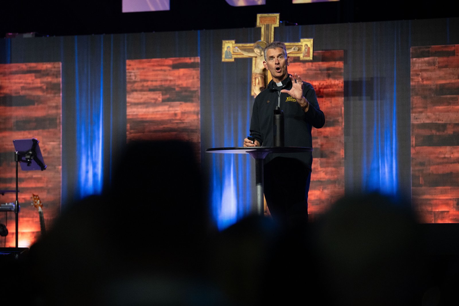 Fr. John Riccardo, a priest of the Archdiocese of Detroit and executive director of ACTS XXIX, speaks during the Eucharistic revival at Huntington Place. (Tim Fuller | Detroit Catholic)