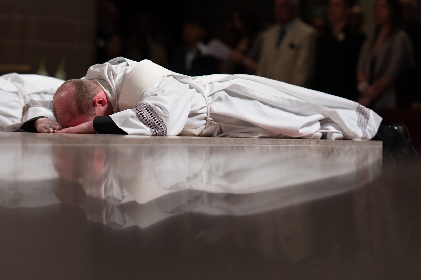 The ordinands lie prostrate before the altar as the Litany of the Saints is chanted prior to the ordination rite.