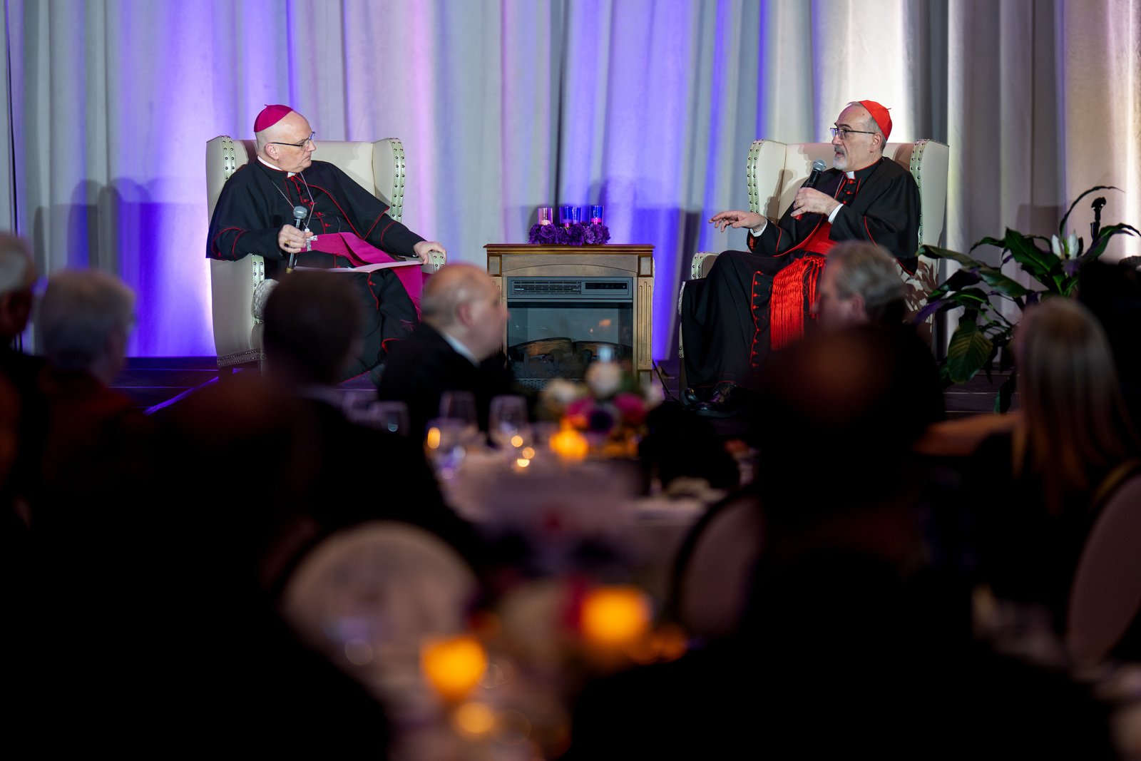 Archbishop Weisenburger, left, talks with Cardinal Pierbattista Pizzaballa, the Latin patriarch of Jerusalem, during a "fireside chat" at St. John's Resort in Plymouth during the patriarch's historic December 2025 pastoral visit to Detroit to raise support for beleaguered and war-torn communities in the Holy Land. (Tim Fuller | Special to Detroit Catholic)