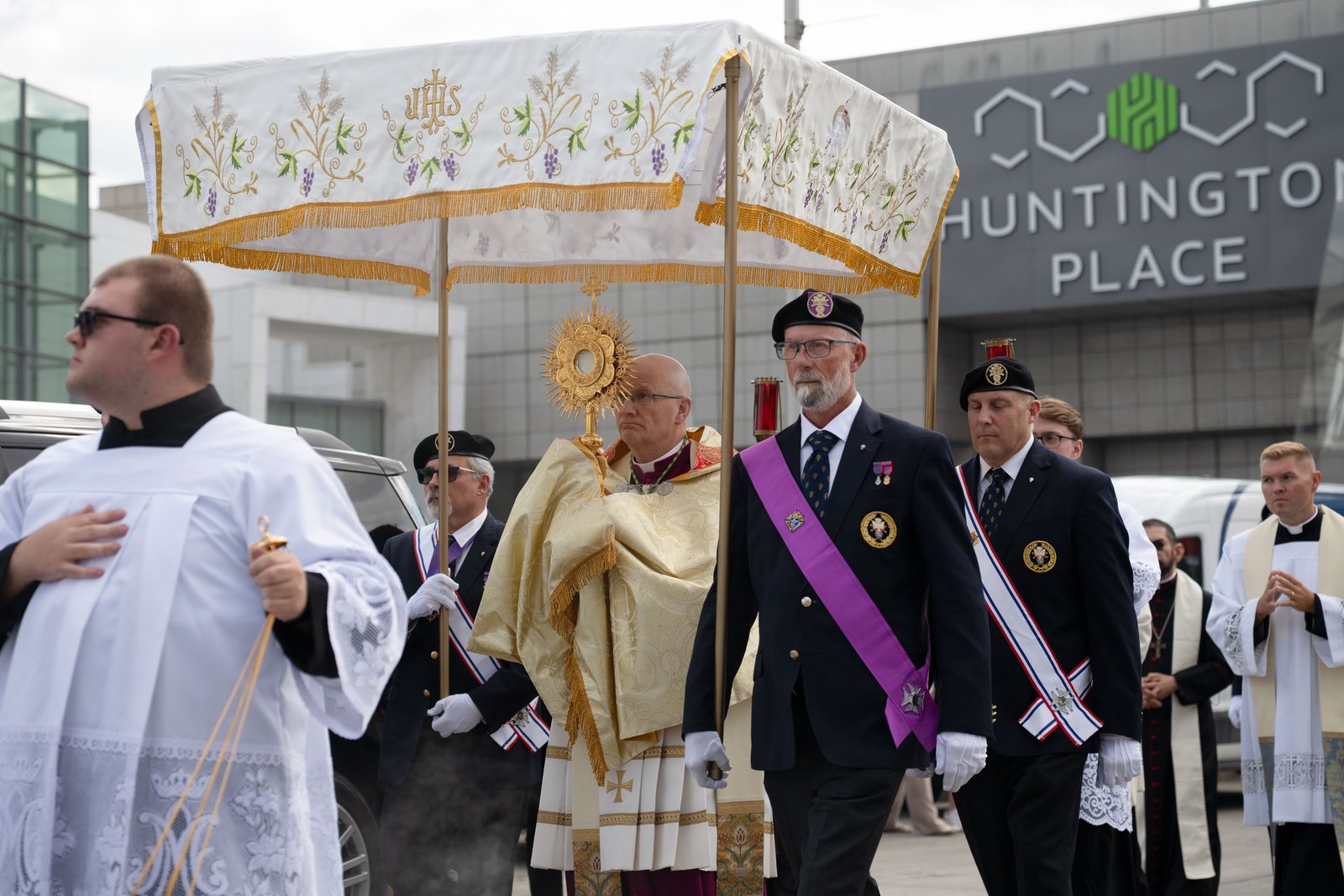 Archbishop Weisenburger gazes up at the Blessed Sacrament as he carries the Eucharist in procession toward the Spirit of Detroit plaza in downtown Detroit. (Tim Fuller | Detroit Catholic)