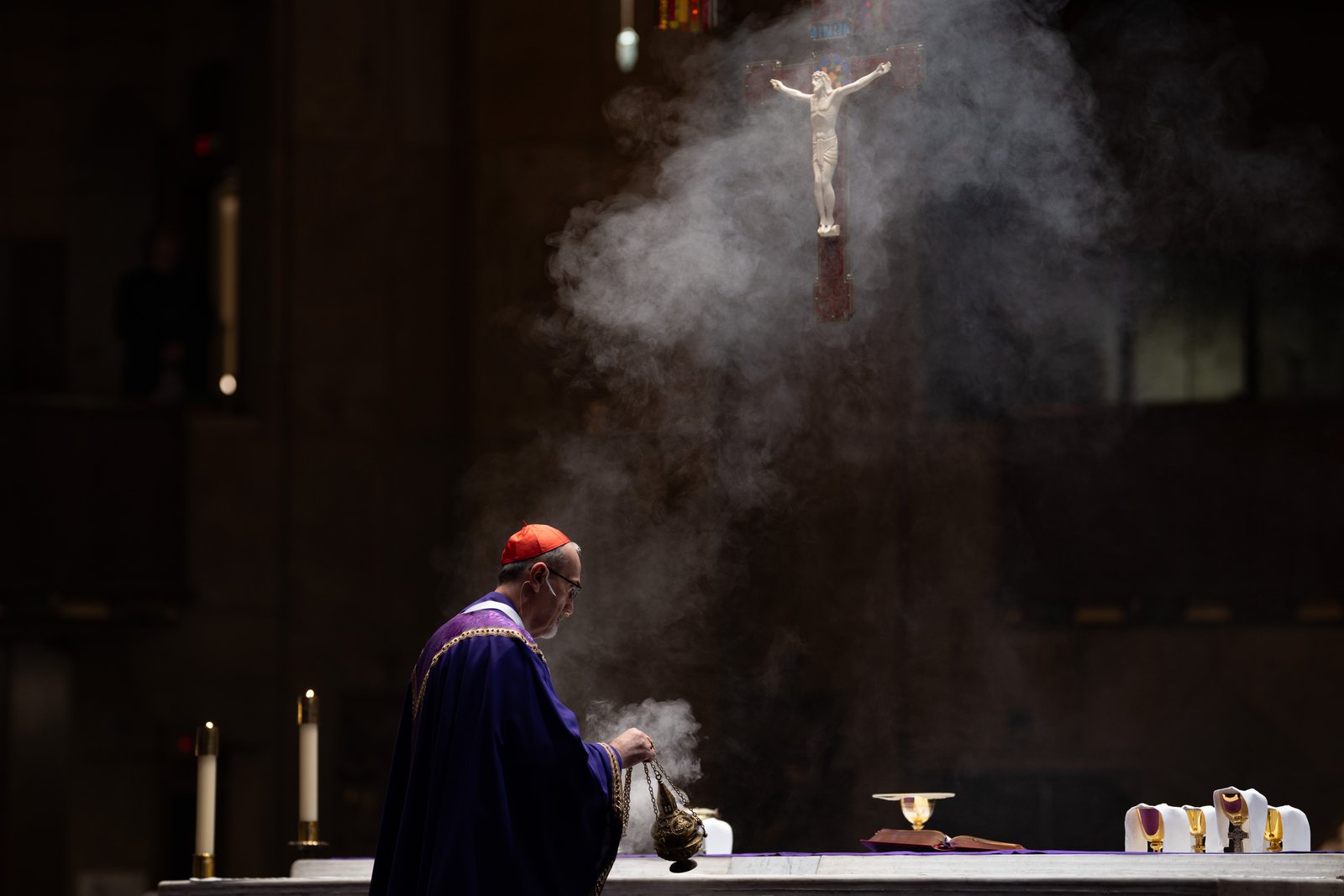 Incense rises to the crucifix above the altar at the National Shrine of the Little Flower Basilica as Cardinal Pierbattista Pizzaballa, OFM, prepares the sanctuary for the Liturgy of the Eucharist. As he departs for Jerusalem, the cardinal said he felt great warmth and support from Detroit's Catholics during his visit.