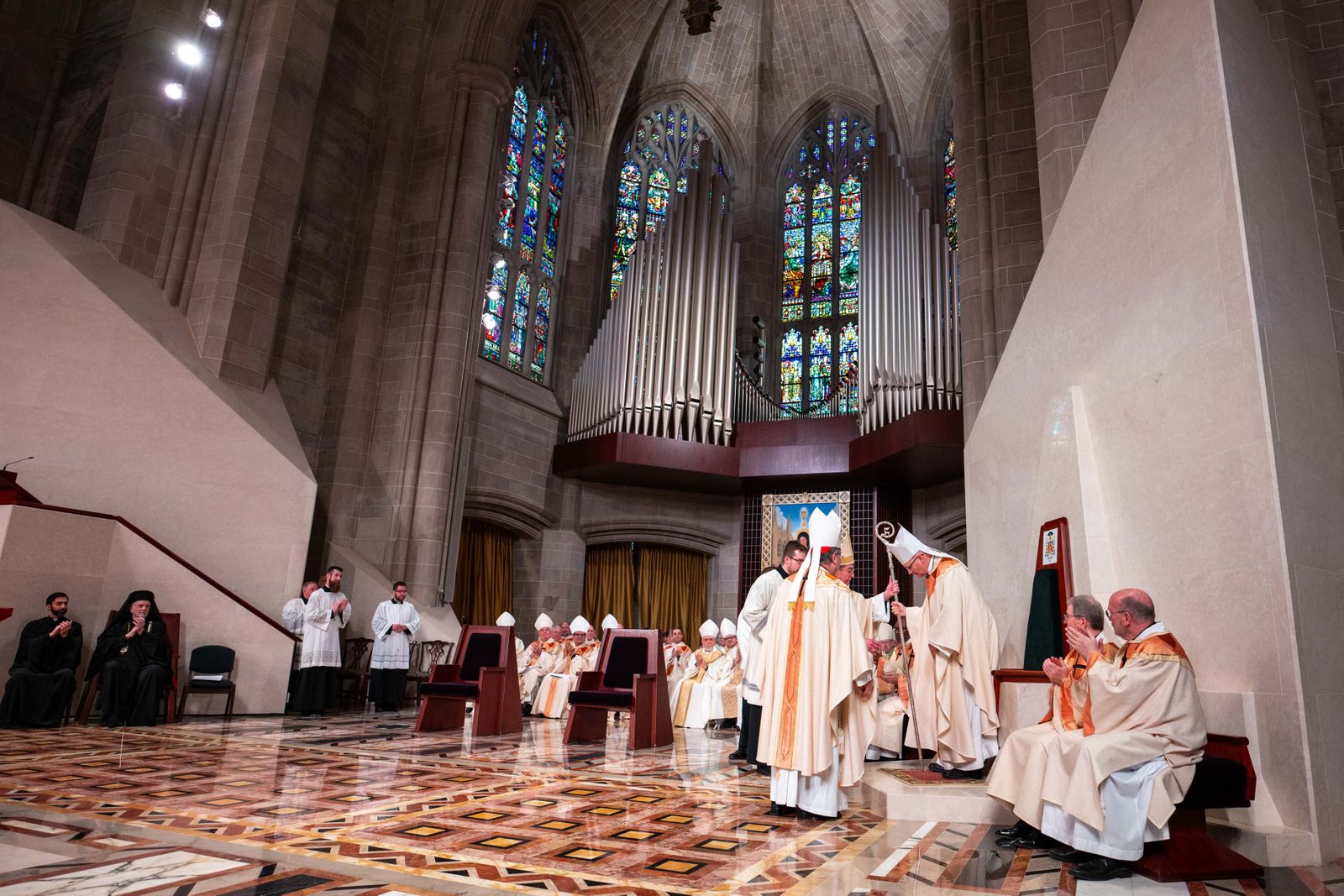 In a moment filled with symbolism and tradition, Archbishop-emeritus Allen H. Vigneron and Cardinal Christophe Pierre, apostolic nuncio to the United States, escort Archbishop Edward J. Weisenburger to his cathedra in the sanctuary of the Cathedral of the Most Blessed Sacrament for the first time during a Mass of installation March 18. (Tim Fuller | Special to Detroit Catholic)