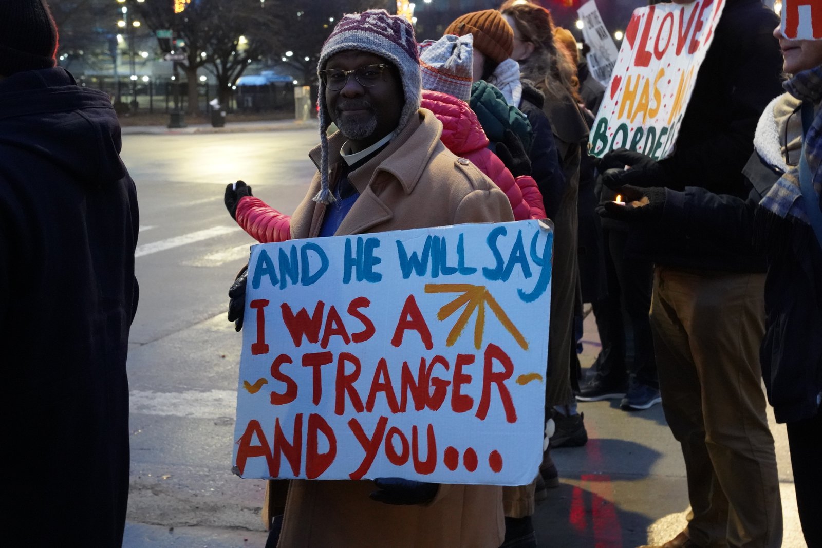 Many people at the demonstration carried faith-based signs calling for recognizing the presence of God in migrants and immigrants.