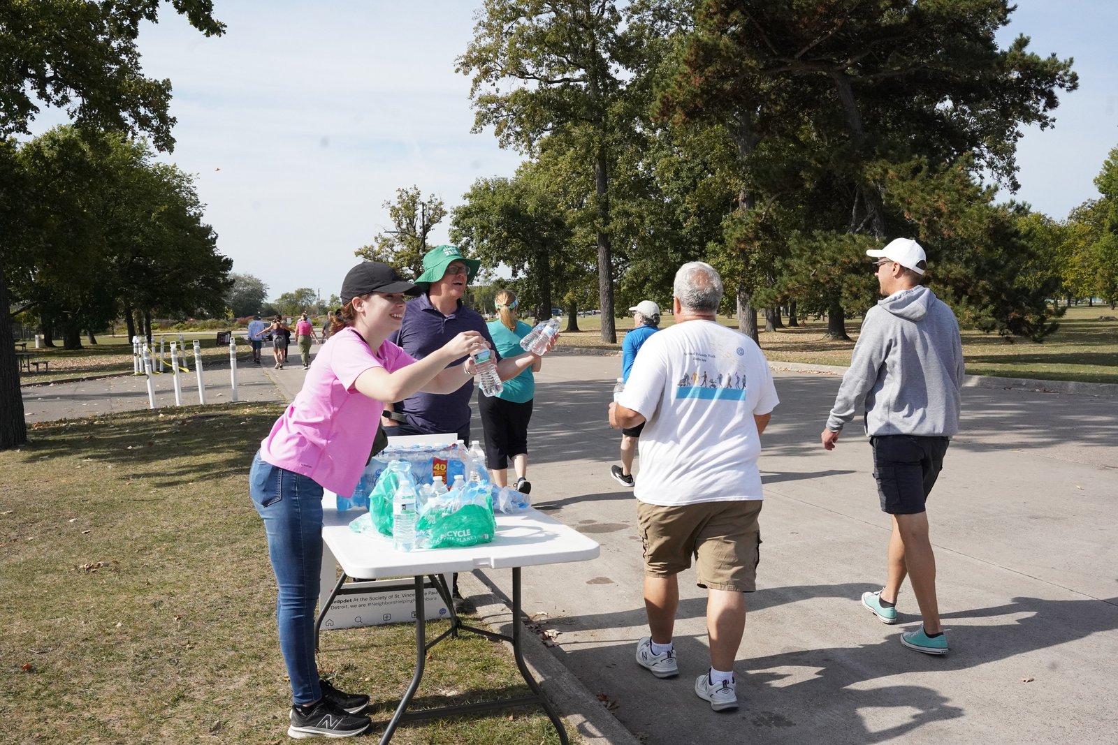 St. Vincent de Paul staff hand out water to volunteer walkers as they continue their 5-kilometer (3.1-mile) walk.
