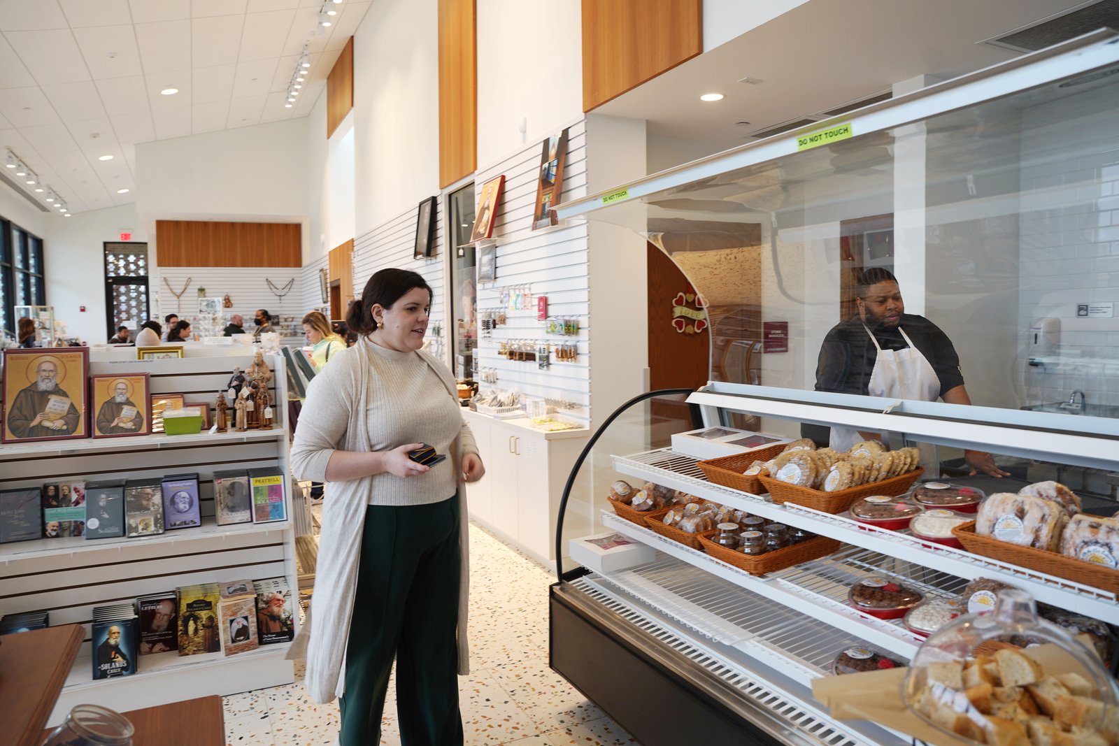 Maggie Jackson, minister for the Solanus Casey YouFra chapter, speaks with staff members of On the Rise Bakery at the Solanus Casey Center. Jackson is one of five YouFra members who made a promise to live out Franciscan values for one year as part of their commitment to YouFra.