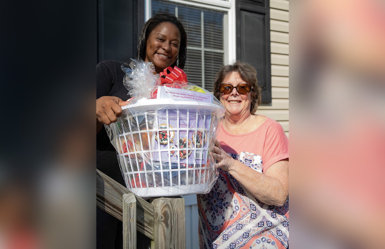 Volunteers with St. Vincent de Paul's Journey to Housing program help a beneficiary move into her new home.